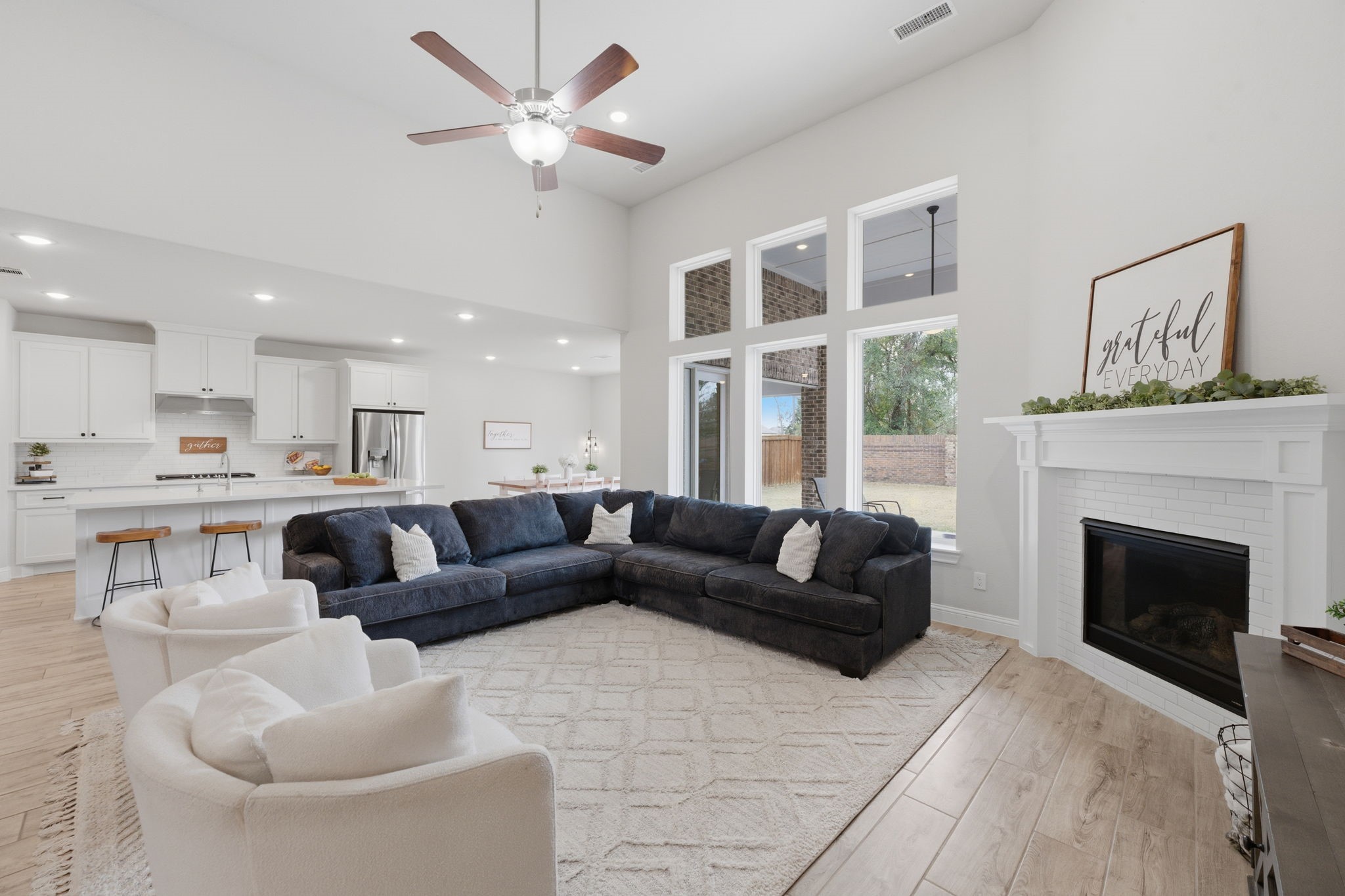 4242 Orchard Pass Drive Spring, TX 77386 - Photo 3 of 50 The Inviting Heart of the Home Has an Open Living Room with Corner Tiled Gas Fireplace Ready for Your Family and Great for Entertaining w/Soaring Ceiling and Large Windows with Views to One of the Covered Patios and Large Rear Yard.