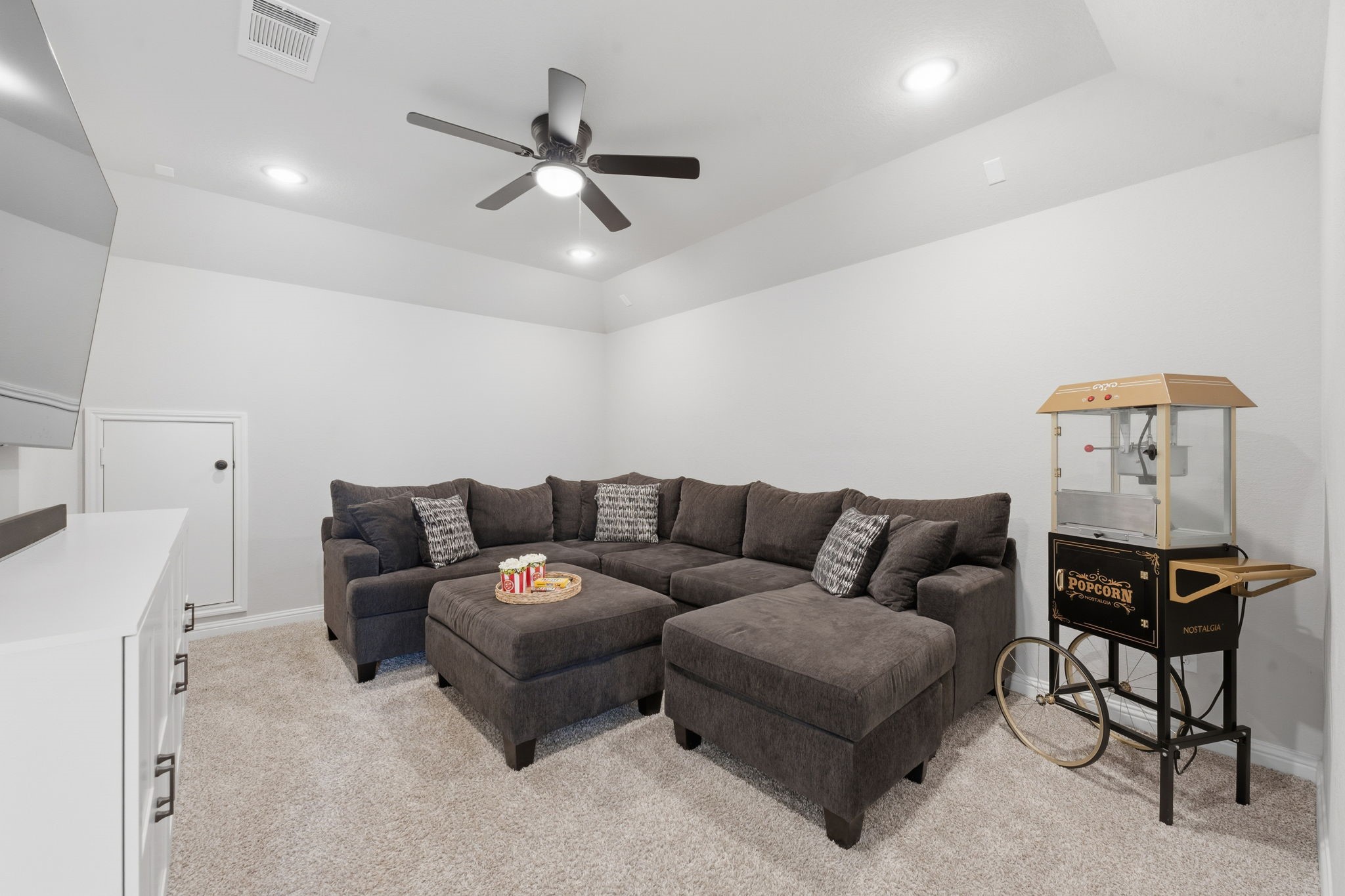 4242 Orchard Pass Drive Spring, TX 77386 - Photo 34 of 50 Upstairs Media Room, Vaulted Ceiling with Fan and Recessed LED Lighting that has access door to attic w/subfloor.