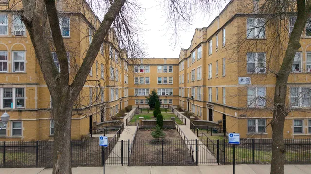 a view of a brick house with large windows