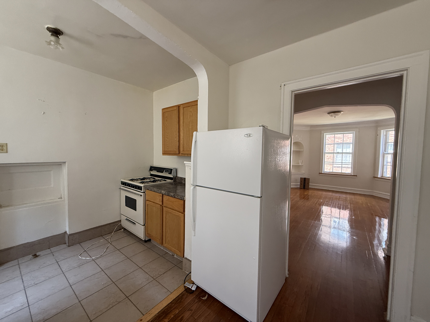 7415 North Damen Avenue, Unit 2E Chicago, IL 60645 - Photo 2 of 8 a white refrigerator freezer and a stove sitting inside of a kitchen
