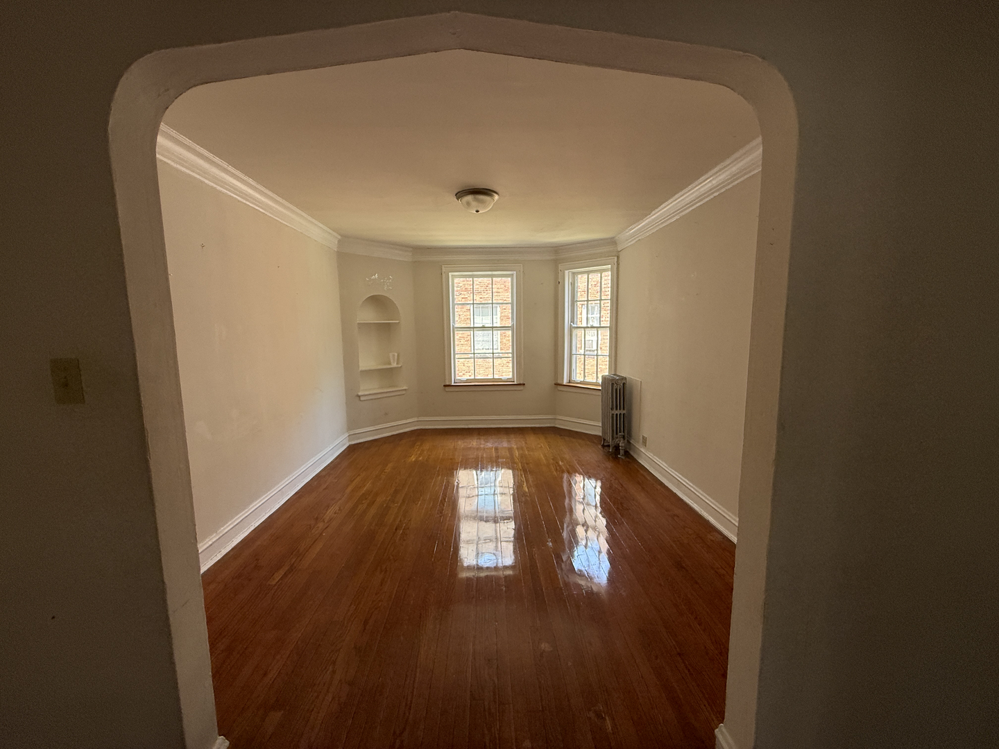 7415 North Damen Avenue, Unit 2E Chicago, IL 60645 - Photo 5 of 8 a view of empty room with wooden floor and fan