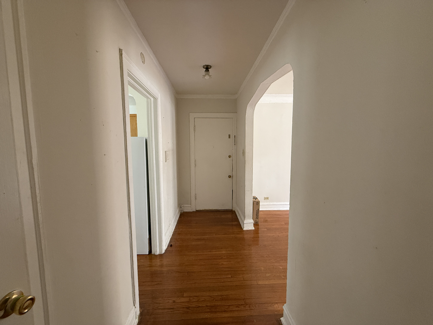 7415 North Damen Avenue, Unit 2E Chicago, IL 60645 - Photo 7 of 8 a view of an empty room with wooden floor and a window