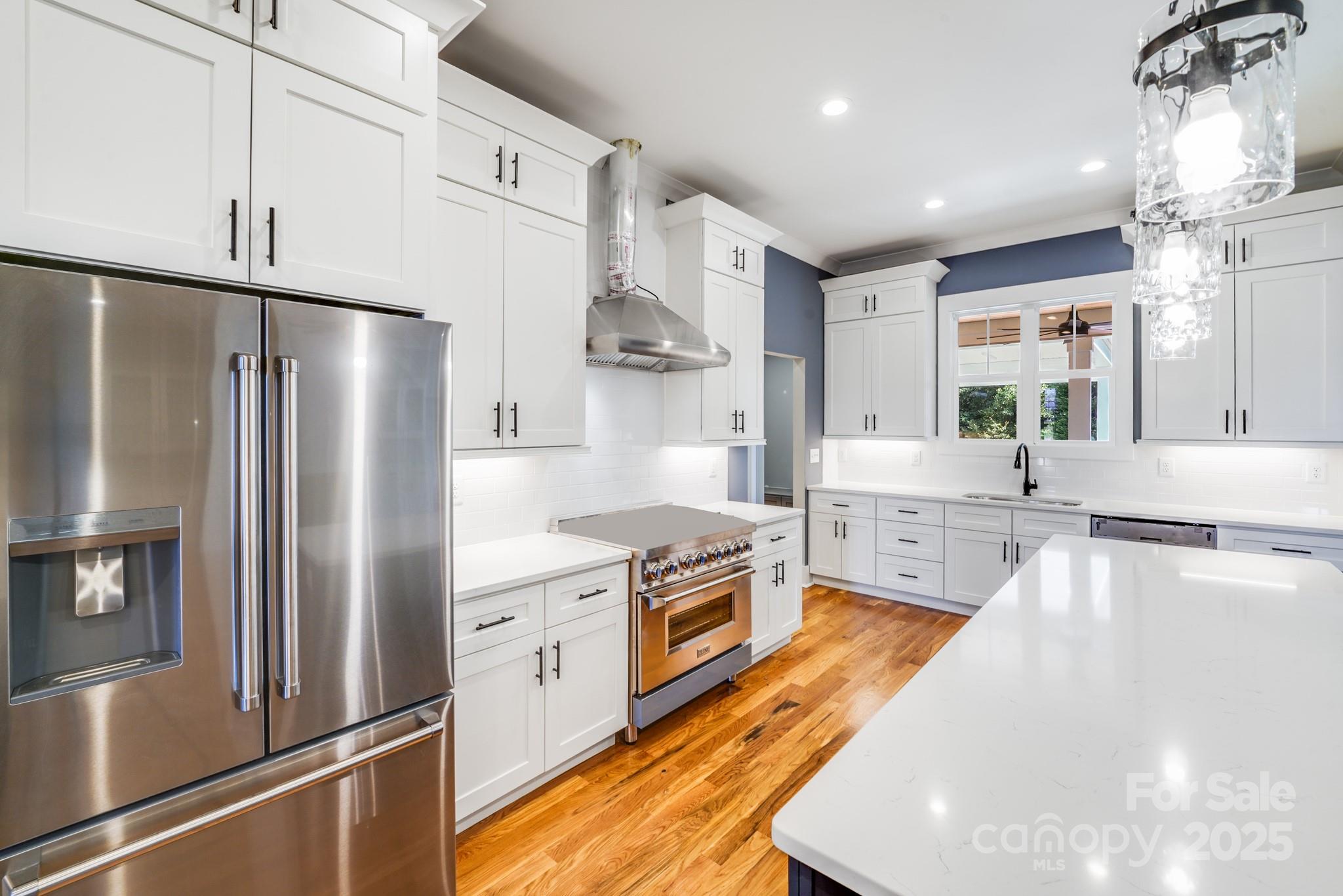 203 Nixon Road Belmont, NC 28012 - Photo 18 of 47 a kitchen with stainless steel appliances granite countertop a refrigerator a sink dishwasher a stove and white cabinets with wooden floor