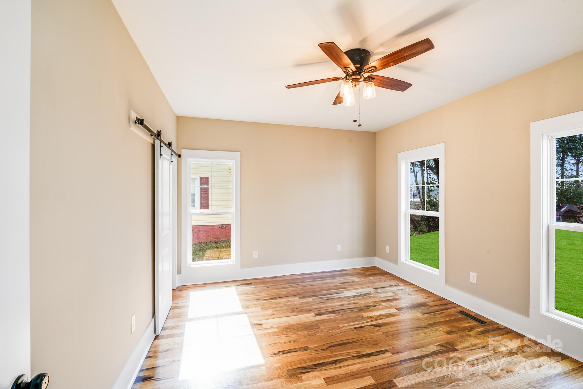 203 Nixon Road Belmont, NC 28012 - Photo 41 of 47 a view of a livingroom with a ceiling fan and wooden floor