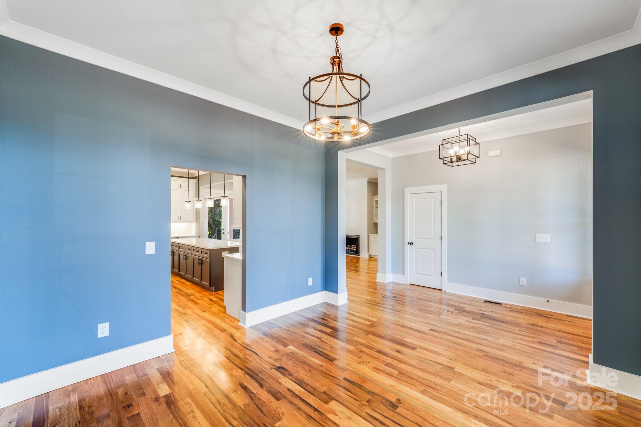 203 Nixon Road Belmont, NC 28012 - Photo 6 of 47 a view of a livingroom with wooden floor and a chandelier