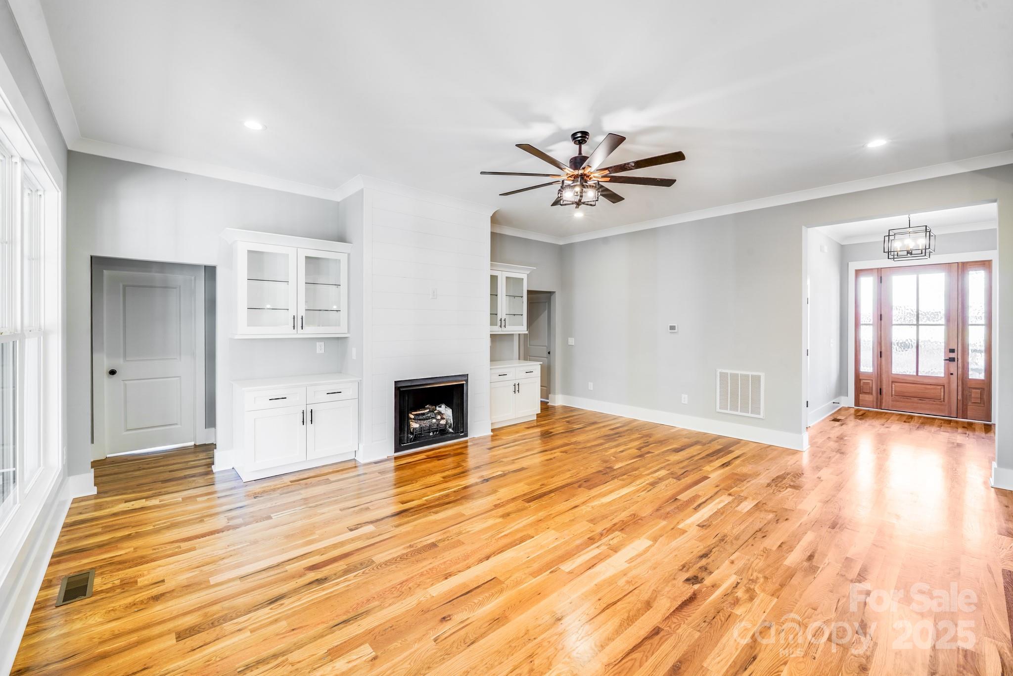 203 Nixon Road Belmont, NC 28012 - Photo 9 of 47 a view of empty room with wooden floor and fireplace