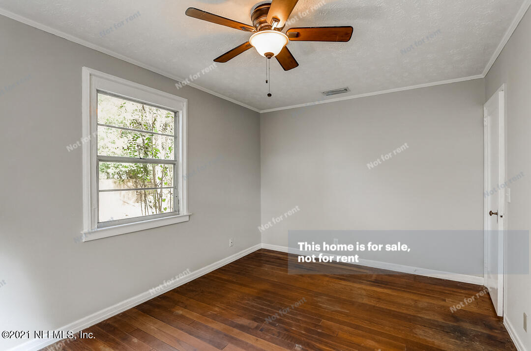 4617 Pinewood Road Jacksonville, FL 32210 - Photo 16 of 18 a view of an empty room with window and a chandelier fan