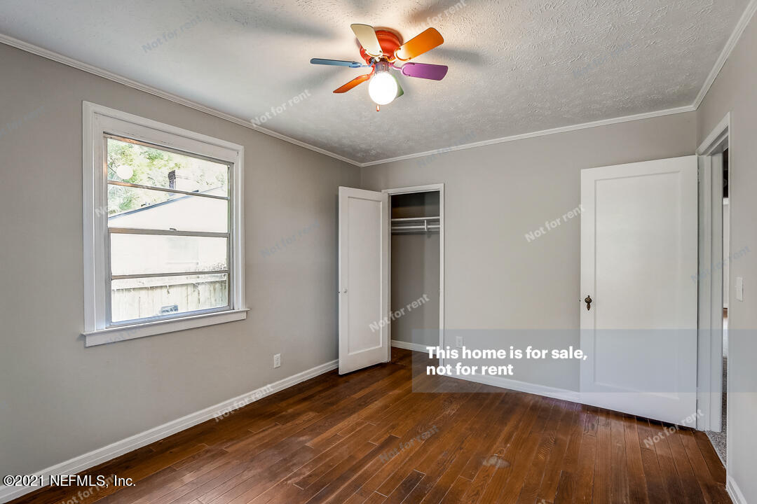 4617 Pinewood Road Jacksonville, FL 32210 - Photo 18 of 18 wooden floor in an empty room with a window