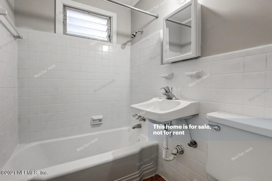 4617 Pinewood Road Jacksonville, FL 32210 - Photo 7 of 18 a bathroom with a sink a toilet and bathtub