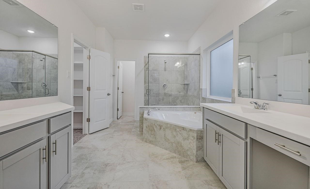 21119 Sunlight Grv Drive Rosharon, TX 77583 - Photo 14 of 14 a spacious bathroom with a shower tub double sink and mirror