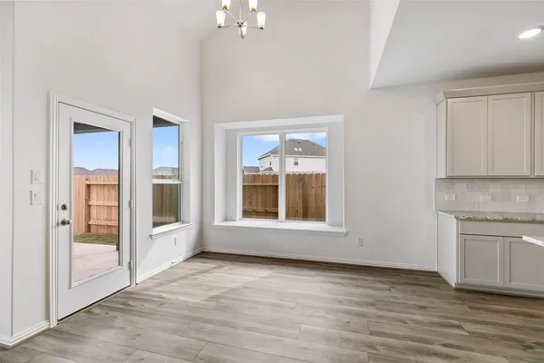 a spacious bathroom with a tub sink shower and mirror