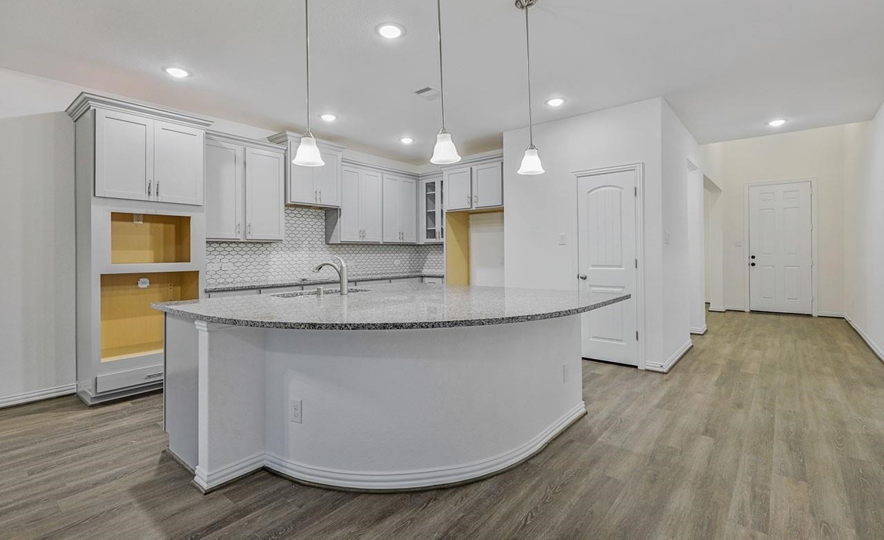 21119 Sunlight Grv Drive Rosharon, TX 77583 - Photo 4 of 14 a view of kitchen with granite countertop cabinets wooden floor and a sink