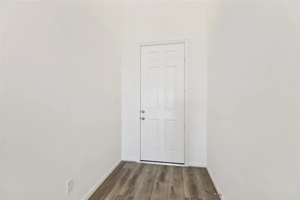 a kitchen with stainless steel appliances granite countertop a lot of counter space and wooden floors
