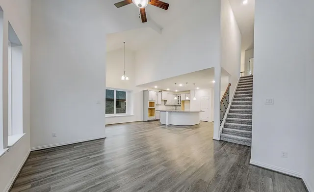 a view of a kitchen with wooden floor and electronic appliances