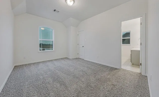 an empty room with windows and entrance