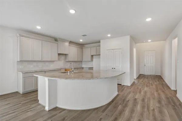 a view of an empty room with glass door and a window
