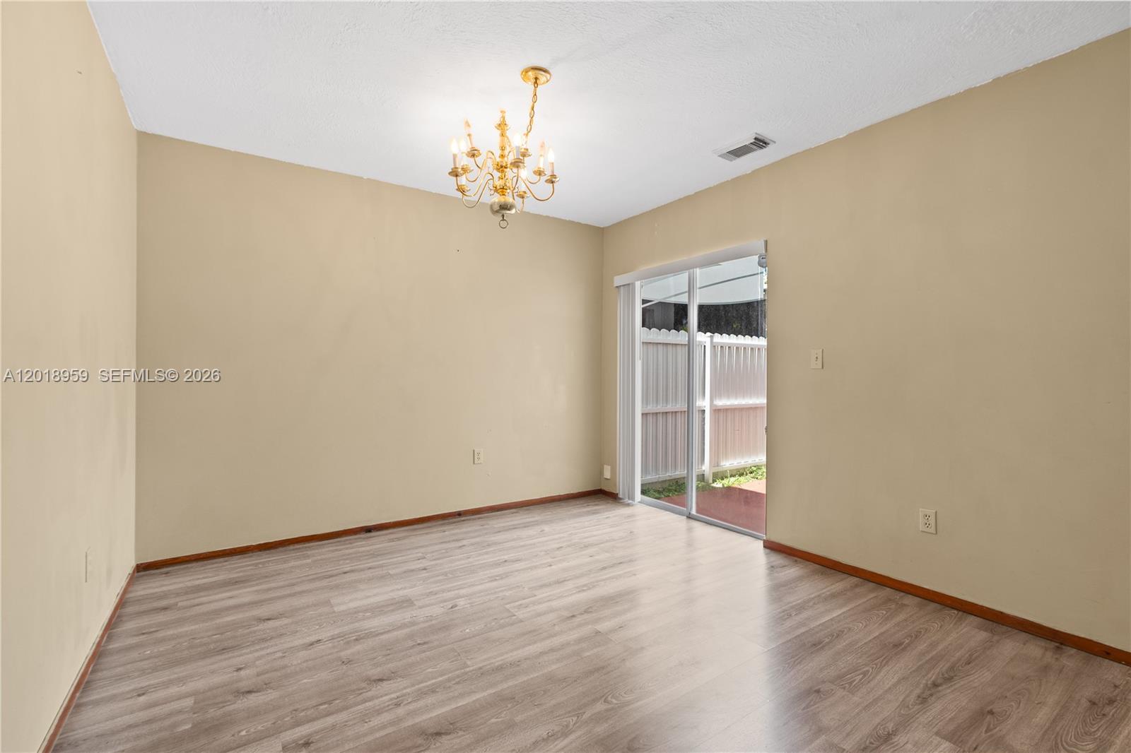 15345 Southwest 63rd Terrace Miami, FL 33193 - Photo 35 of 51 a view of an empty room with wooden floor and a window