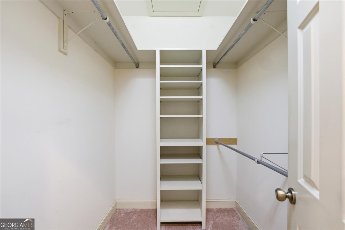 2040 Wynbrooke Place Madison, GA 30650 - Photo 11 of 60 a view of walk in closet with empty racks