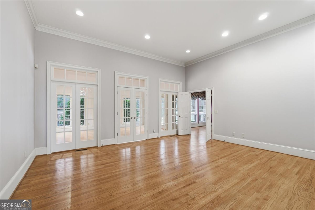 2040 Wynbrooke Place Madison, GA 30650 - Photo 15 of 60 a view of an empty room with wooden floor and a window