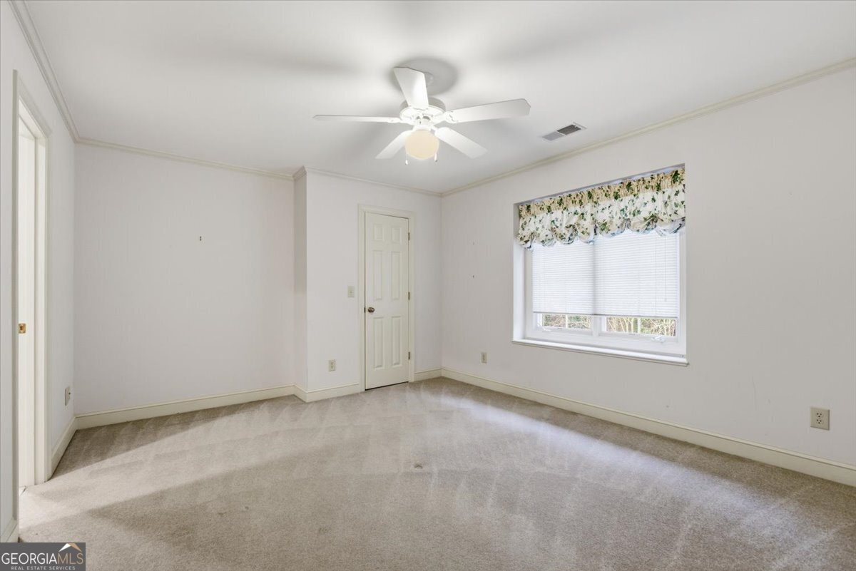 2040 Wynbrooke Place Madison, GA 30650 - Photo 34 of 60 an empty room with a window and a fan
