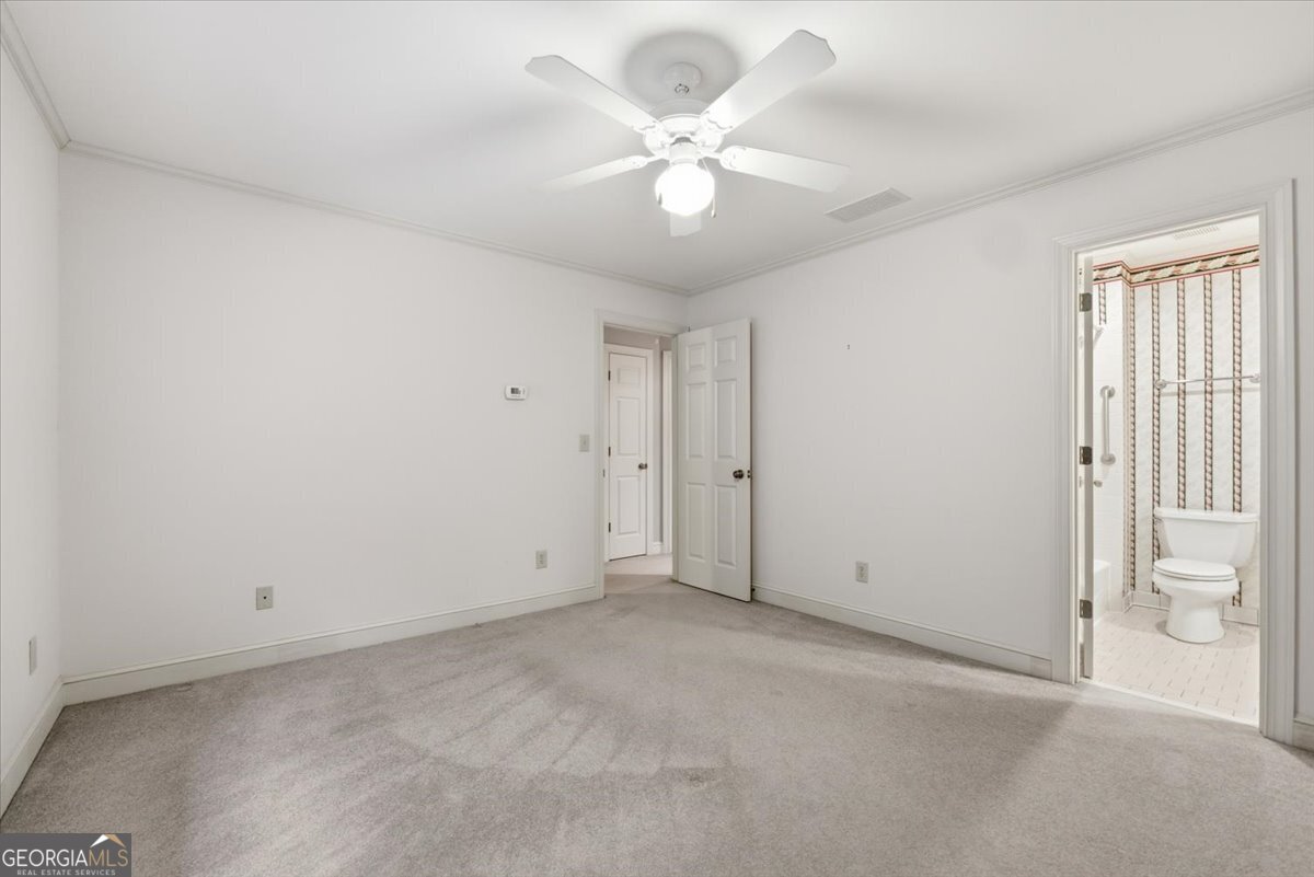2040 Wynbrooke Place Madison, GA 30650 - Photo 35 of 60 an empty room with a ceiling fan and a window