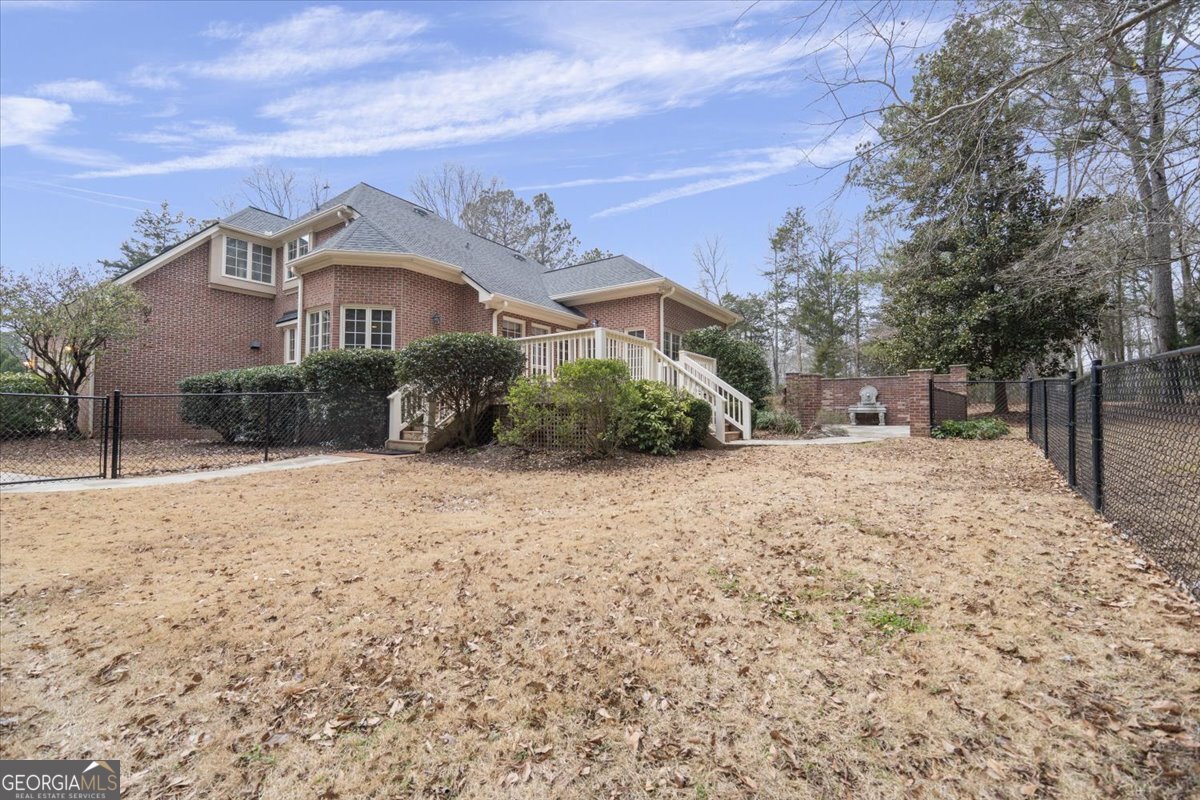 2040 Wynbrooke Place Madison, GA 30650 - Photo 39 of 60 a front view of a house with a yard and garage