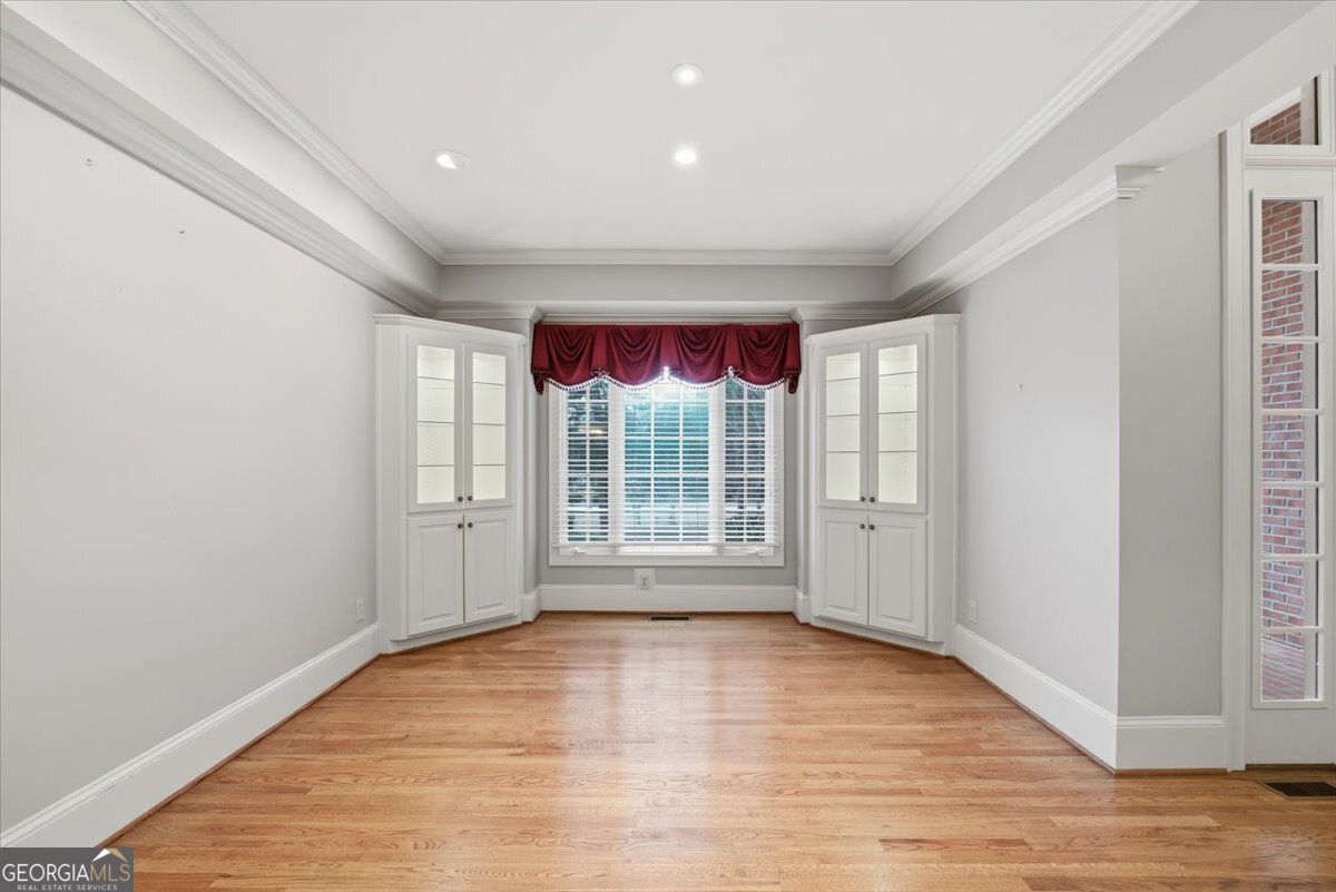 2040 Wynbrooke Place Madison, GA 30650 - Photo 4 of 60 a view of an empty room with wooden floor and a window