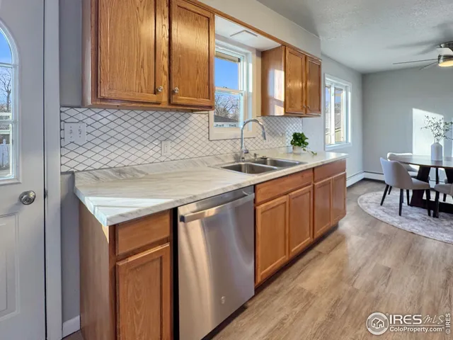 a kitchen with a sink cabinets and wooden floor
