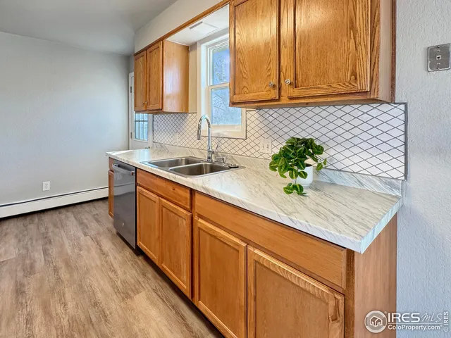a kitchen with stainless steel appliances granite countertop a sink a stove and cabinets
