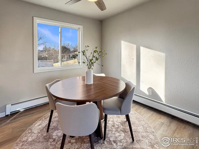 a view of a dining room with furniture and window