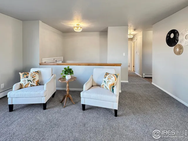 a living room with furniture and a wall painting