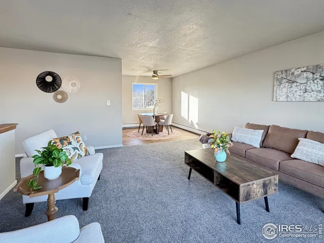 a living room with furniture and flowers