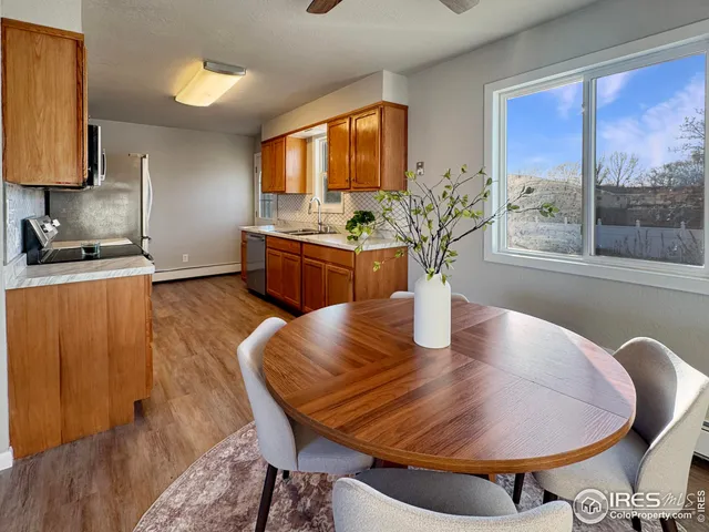 a dining room with furniture and wooden floor