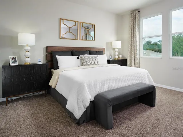 a bedroom with a bed and a night stand