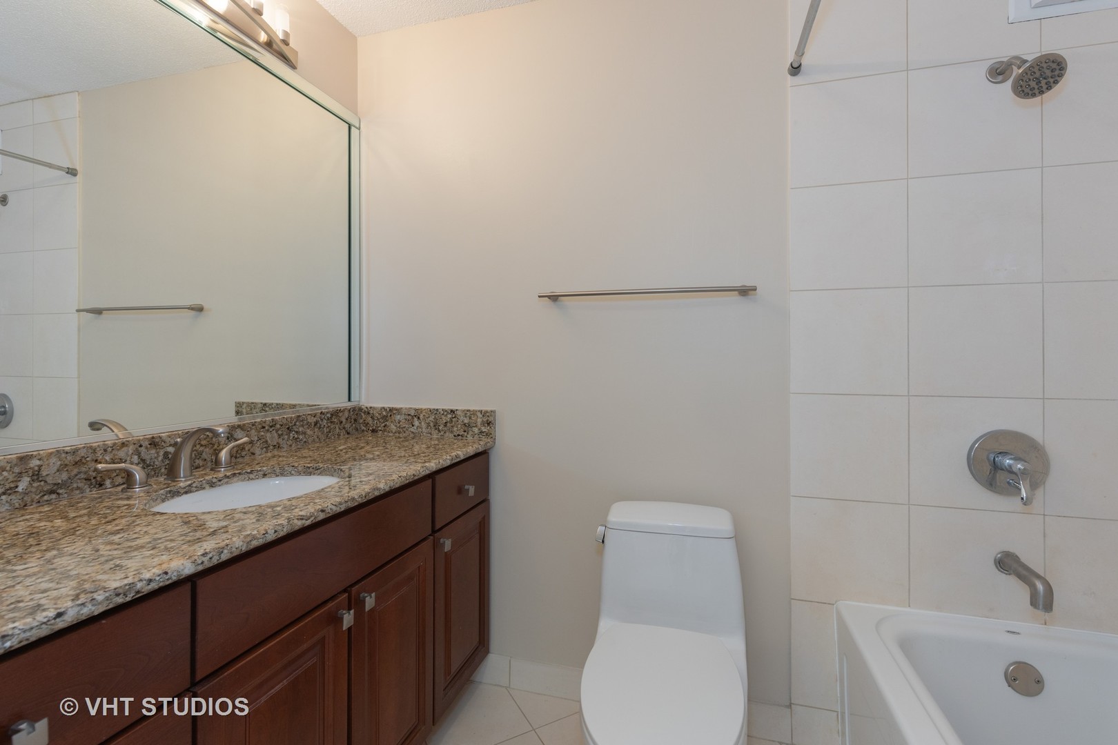 405 North Wabash Avenue, Unit 1701 Chicago, IL 60611 - Photo 2 of 13 a bathroom with a granite countertop sink toilet and mirror