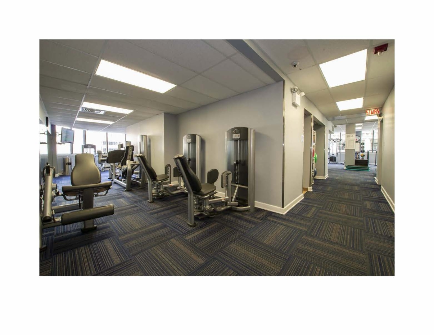 405 North Wabash Avenue, Unit 1701 Chicago, IL 60611 - Photo 10 of 13 a living room with lots of furniture and gym equipment