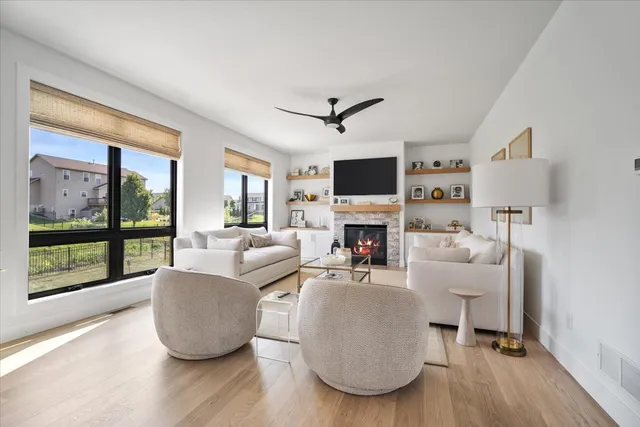 a living room with furniture a fireplace and a flat screen tv