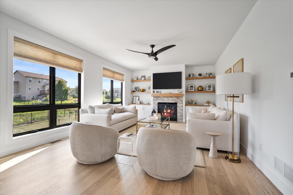 5305 Finlen Lane Bloomington, IL 61705 - Photo 14 of 42 a living room with furniture a fireplace and a flat screen tv