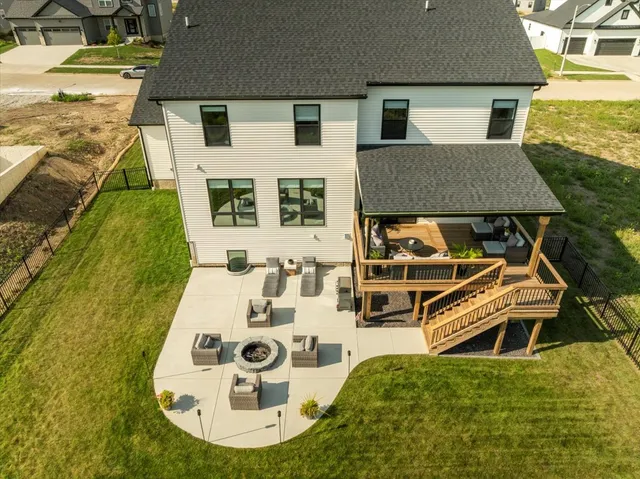 an aerial view of a house with swimming pool garden and patio