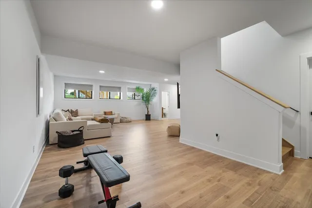a living room with furniture and a wooden floor