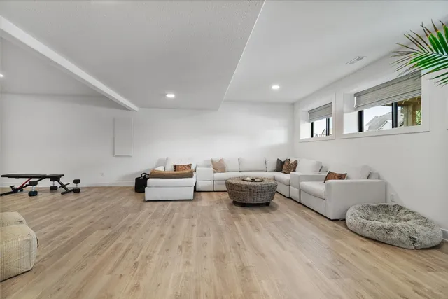a living room with furniture and wooden floor