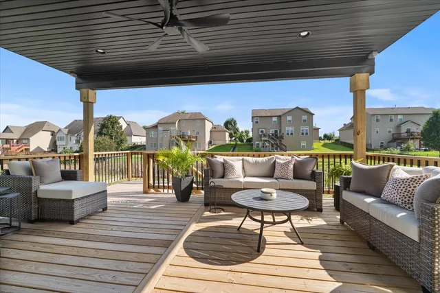a living room with furniture and a floor to ceiling window