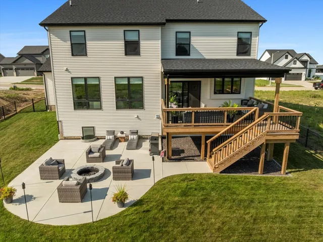 a view of a house with backyard porch and sitting area
