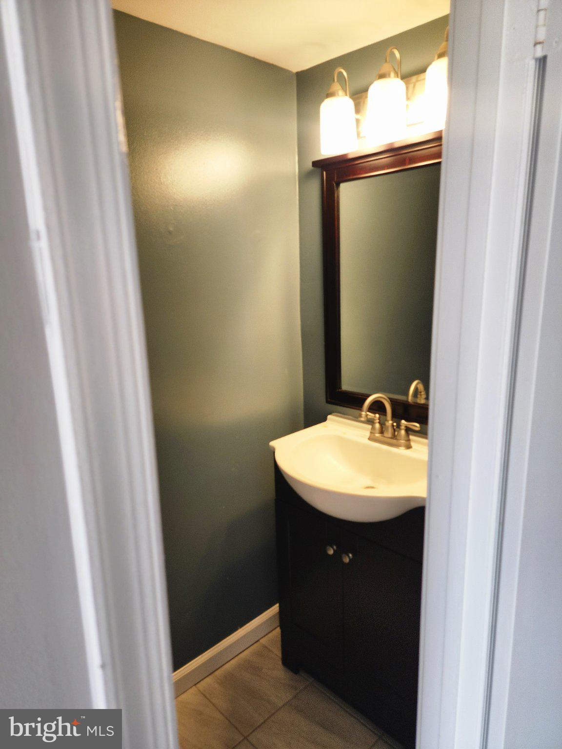 2384 Mitchellville Road Bowie, MD 20716 - Photo 12 of 44 a bathroom with a sink and a mirror