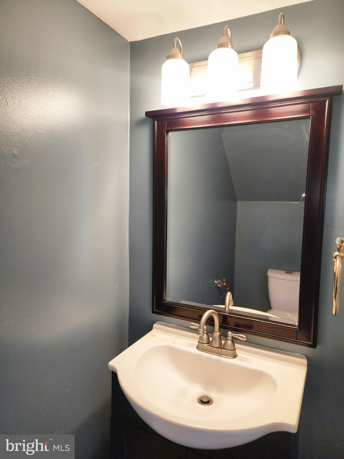 2384 Mitchellville Road Bowie, MD 20716 - Photo 13 of 44 a bathroom with a sink and a mirror