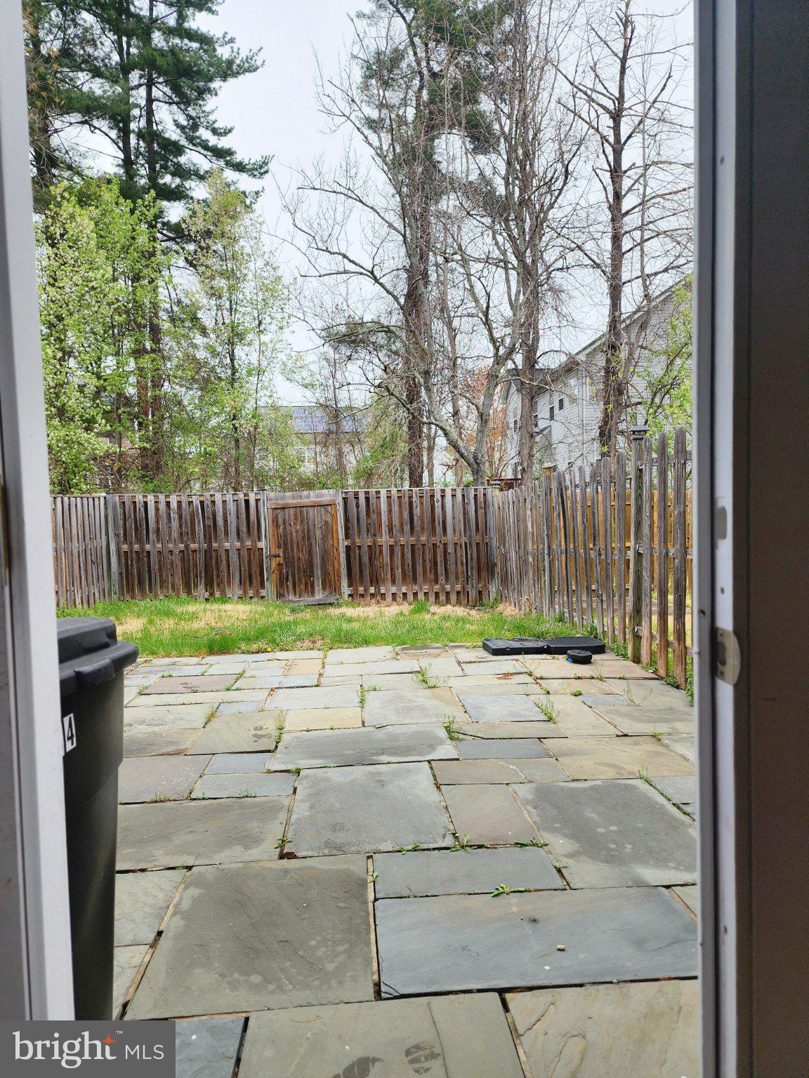 2384 Mitchellville Road Bowie, MD 20716 - Photo 20 of 44 a view of a yard with wooden fence and trees