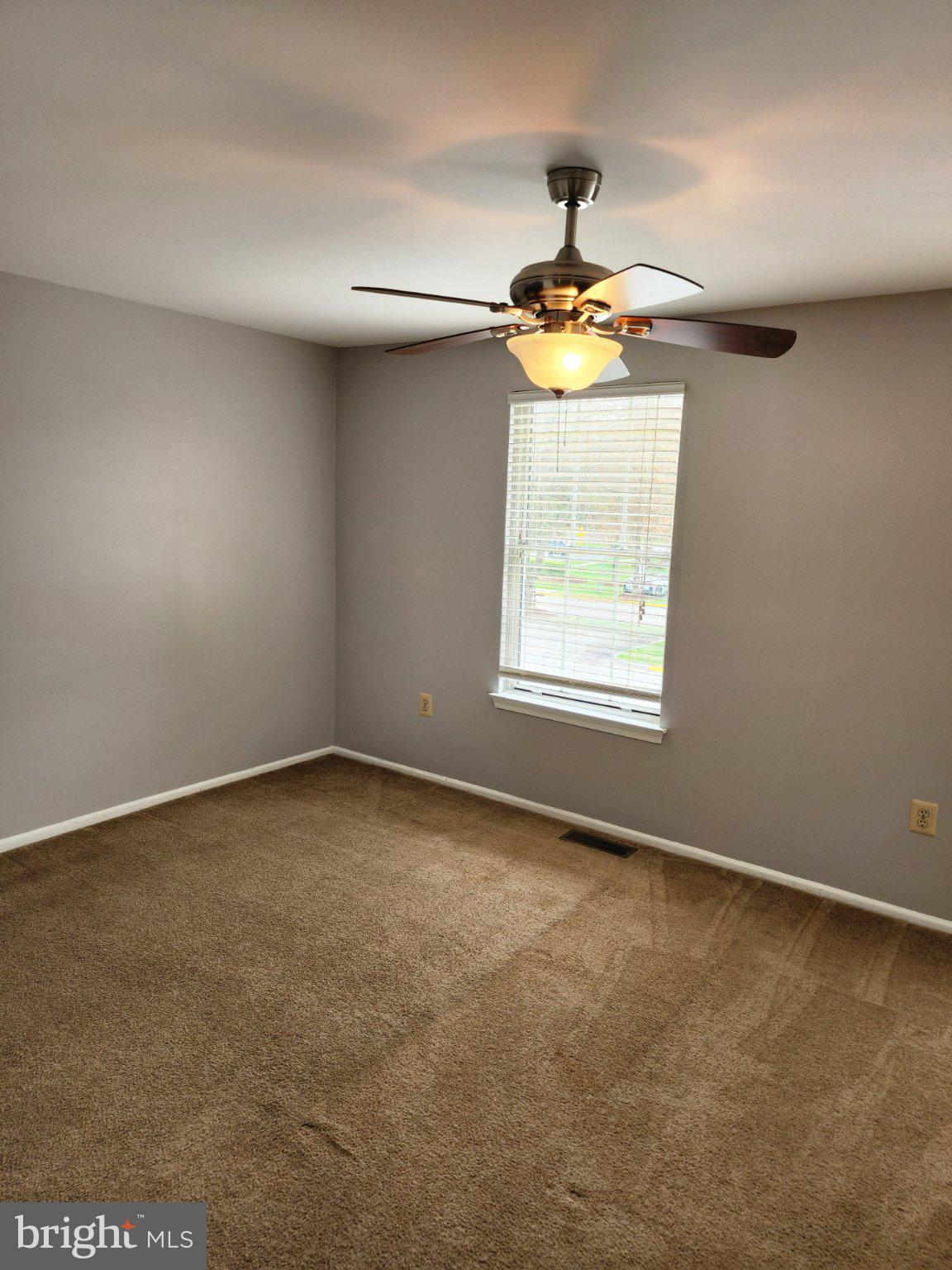2384 Mitchellville Road Bowie, MD 20716 - Photo 28 of 44 an empty room with a window and a ceiling fan