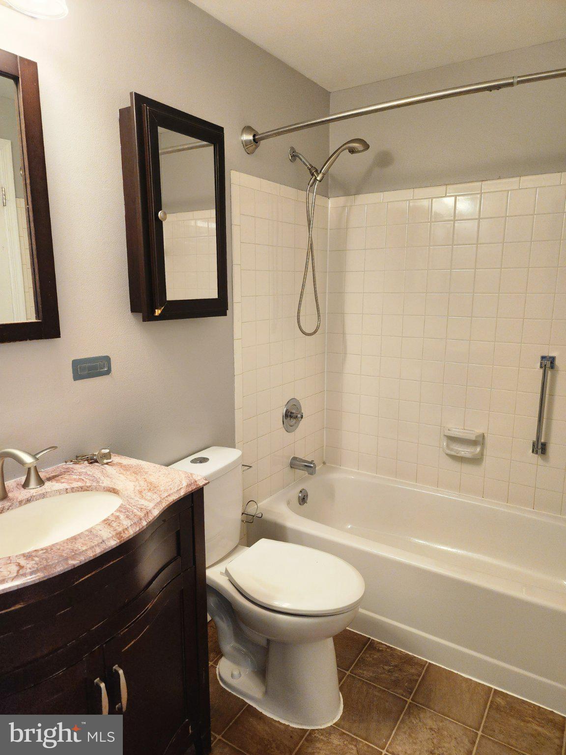 2384 Mitchellville Road Bowie, MD 20716 - Photo 33 of 44 a bathroom with a sink a toilet and shower