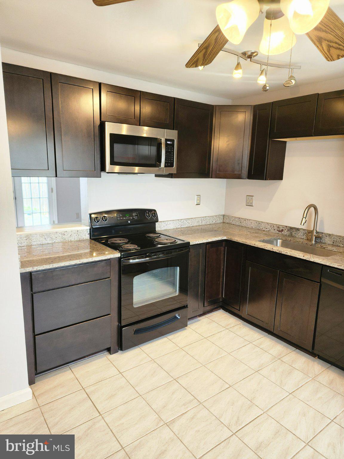 2384 Mitchellville Road Bowie, MD 20716 - Photo 7 of 44 a kitchen with stainless steel appliances a sink and a microwave