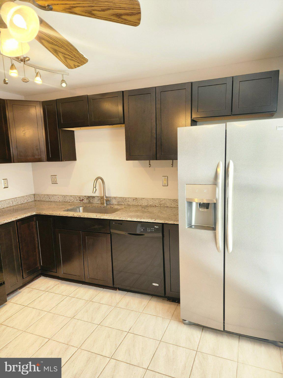 2384 Mitchellville Road Bowie, MD 20716 - Photo 9 of 44 a kitchen with granite countertop a refrigerator and a sink